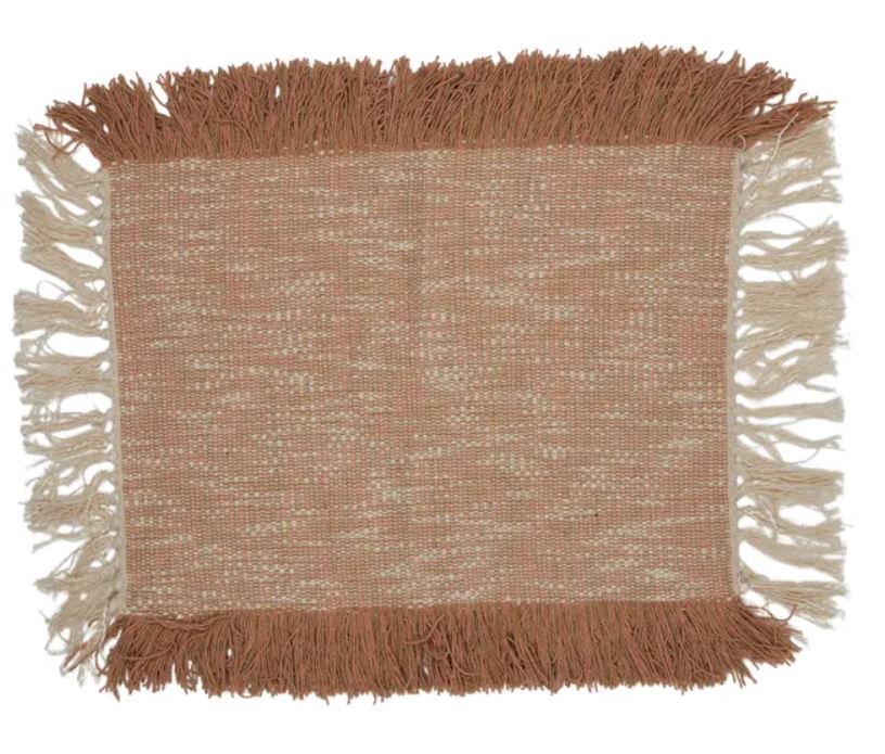 Textured placemat with fringes on a white background