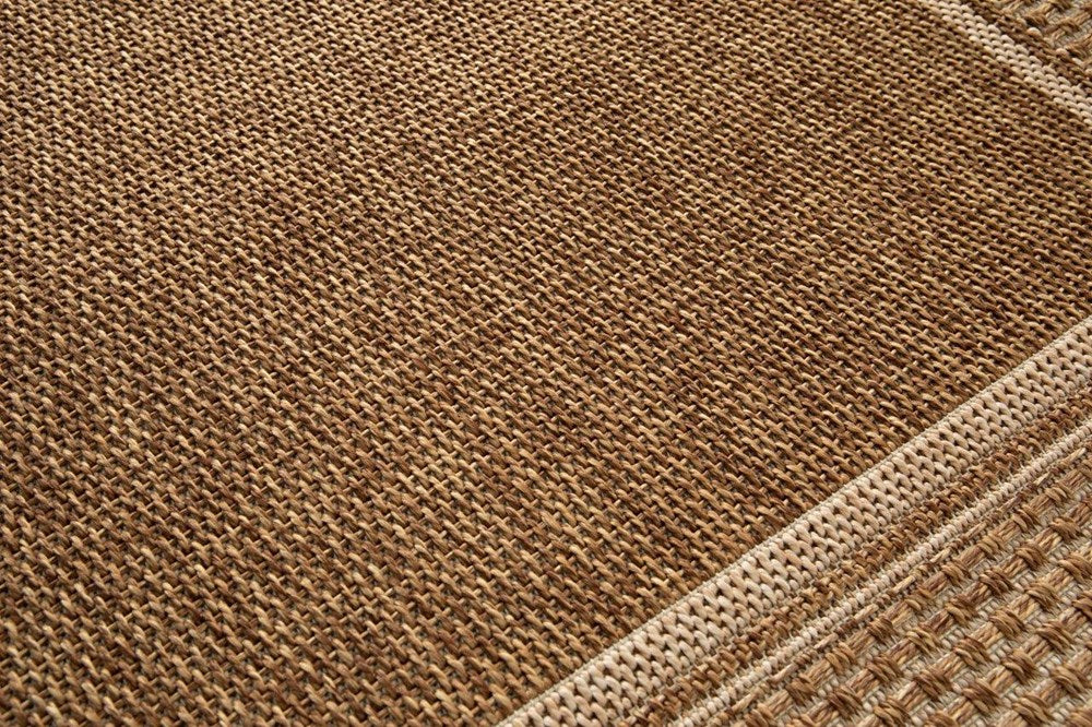 Close-up of a brown textured fabric with a geometric pattern