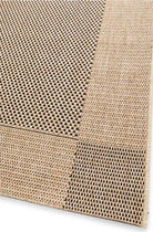 Close-up of a textured beige rug with a grid pattern on a white background