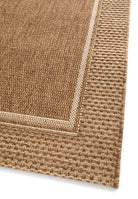 Close-up of a textured brown rug corner on a white background