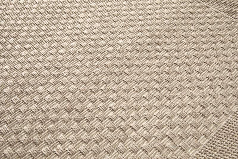 Close-up of a textured beige fabric with a diamond pattern