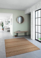 Patterned rug on a gray floor with a light green wall and large window.
