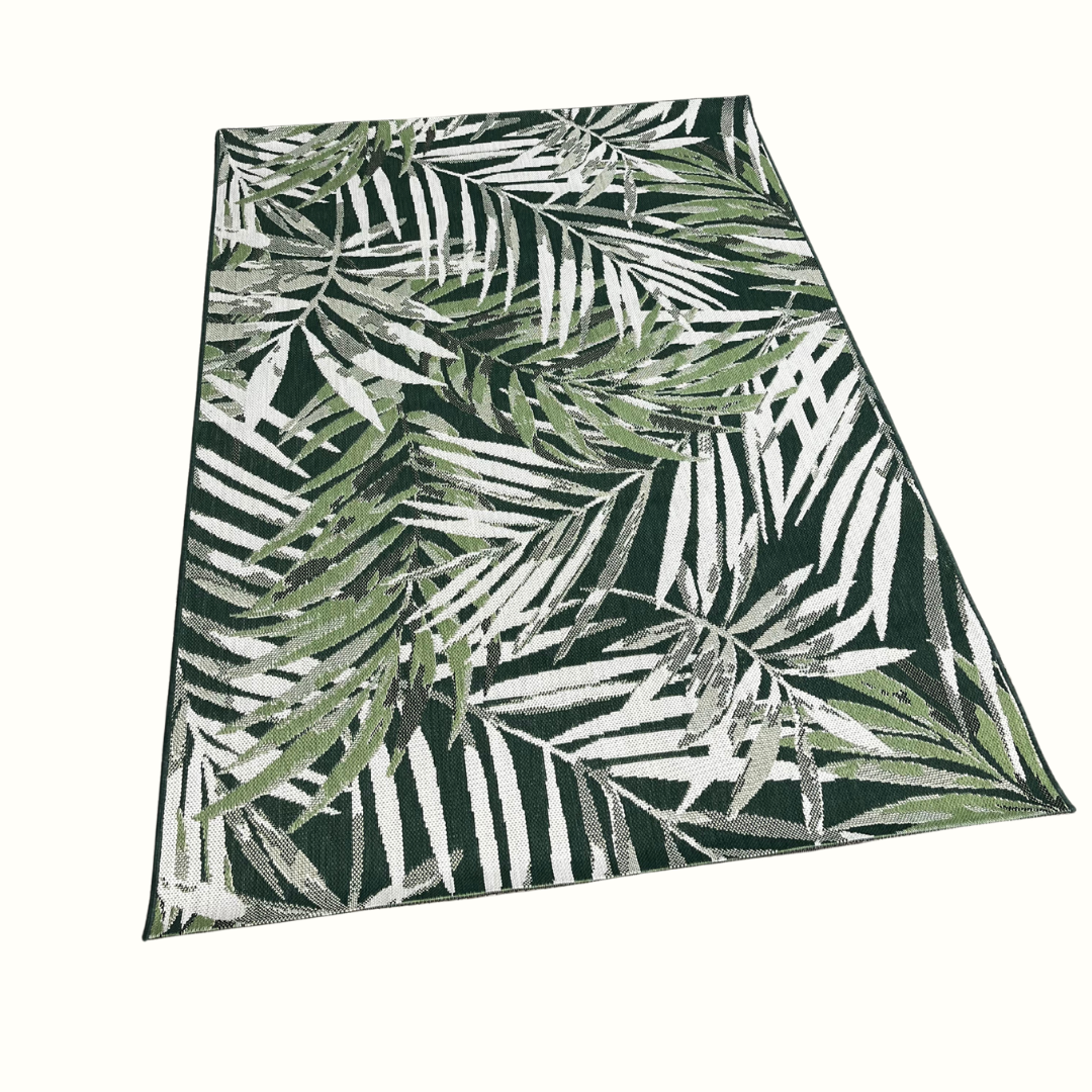 Rug with green and white leaf pattern on a white background