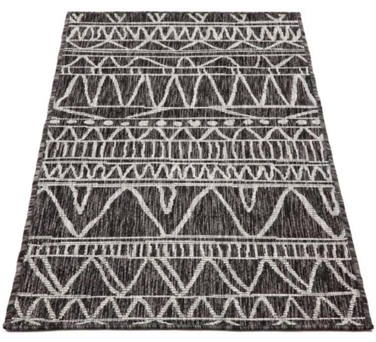 Black and white patterned rug on a white background