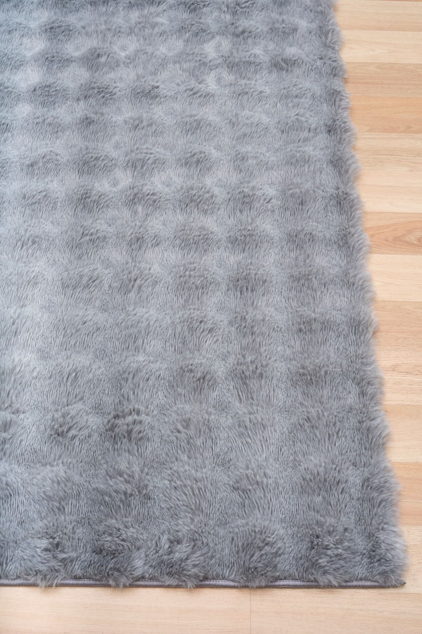 Gray shaggy rug on a wooden floor