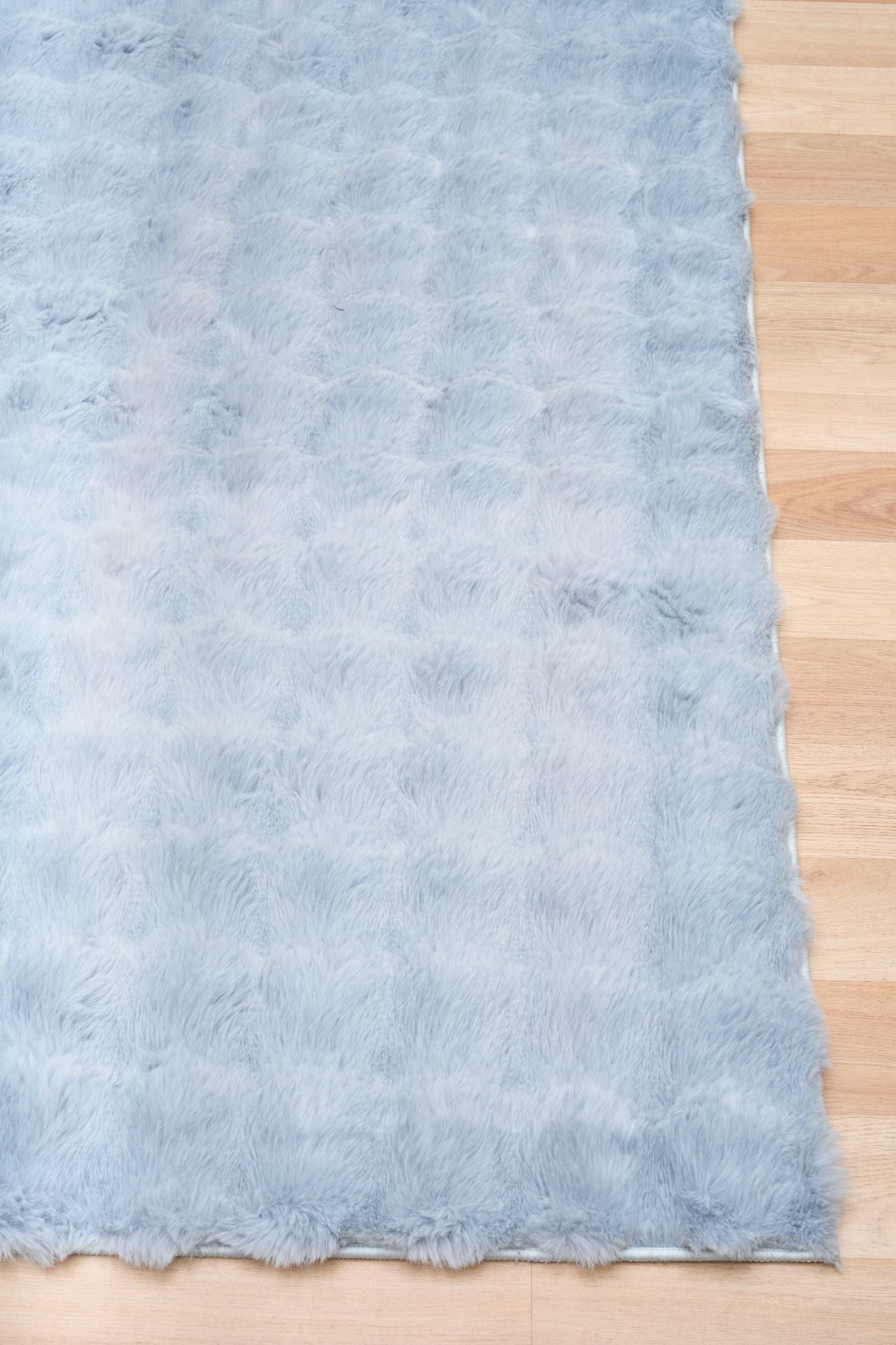Light blue textured fabric on a wooden surface