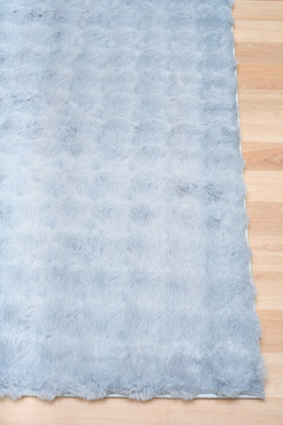 Light blue textured fabric on a wooden surface
