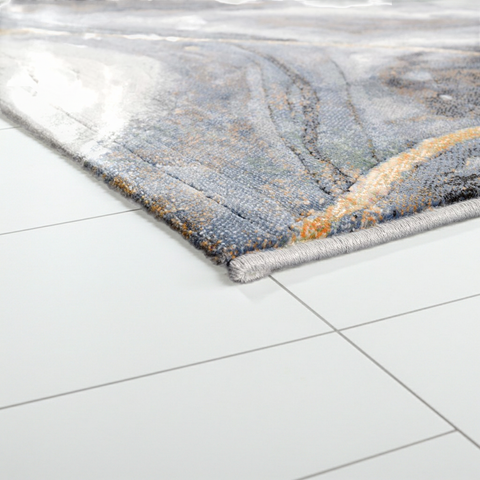 Decorative rug with abstract pattern on a white tiled floor