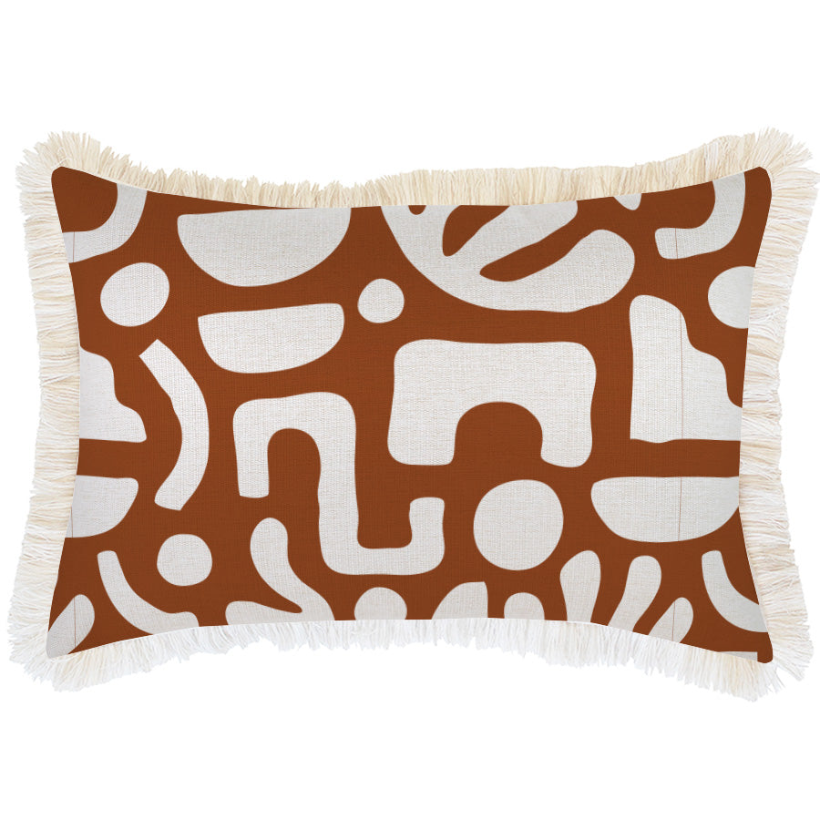 A square decorative throw pillow with a rust brown and cream abstract pattern and white fringe trim, shown against a plain white background.