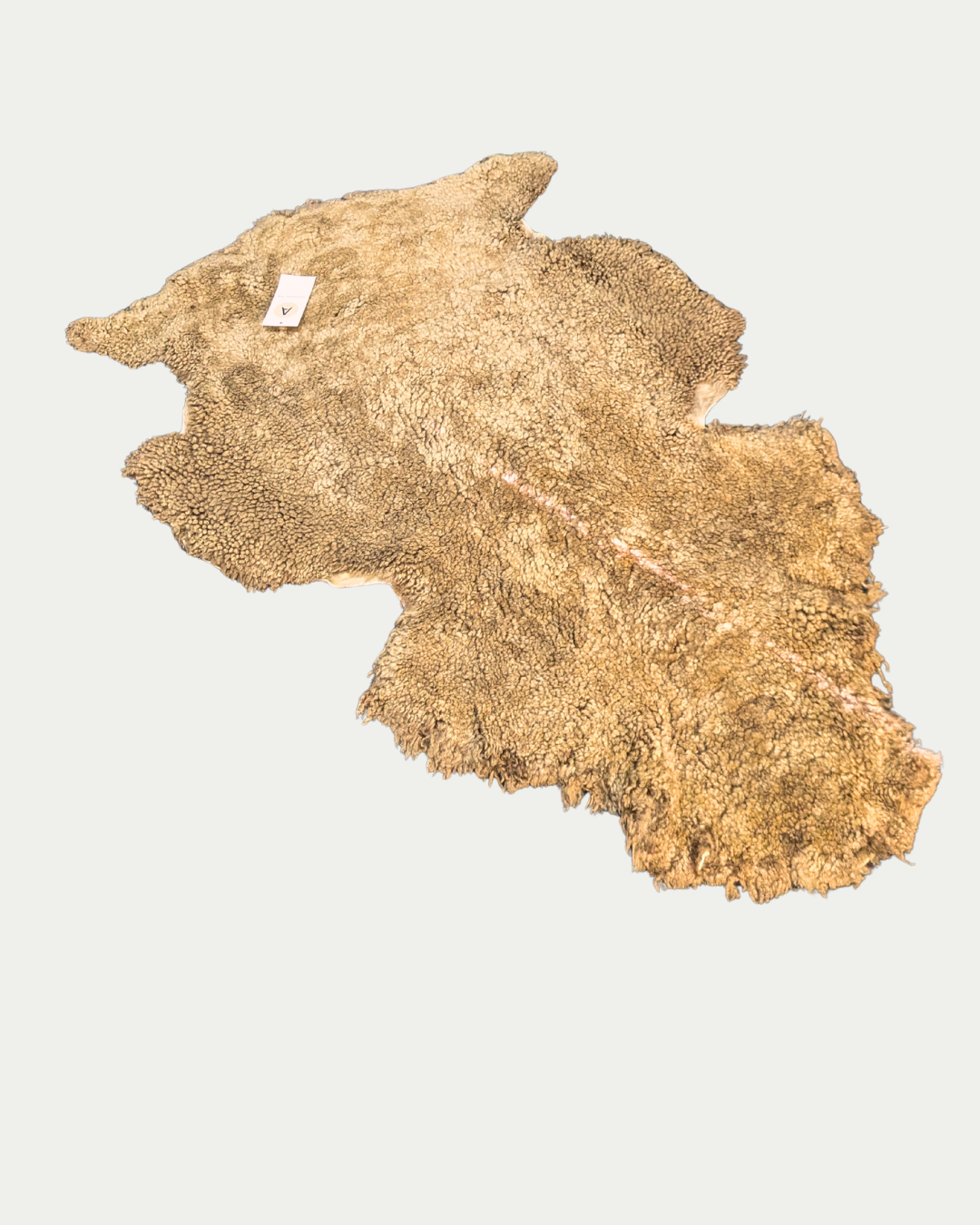 Dark pet sheepskin rug on white background