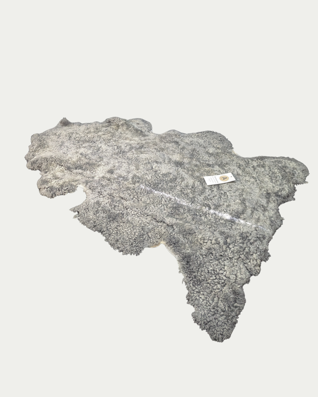 Grey sheepskin pet rug on white background