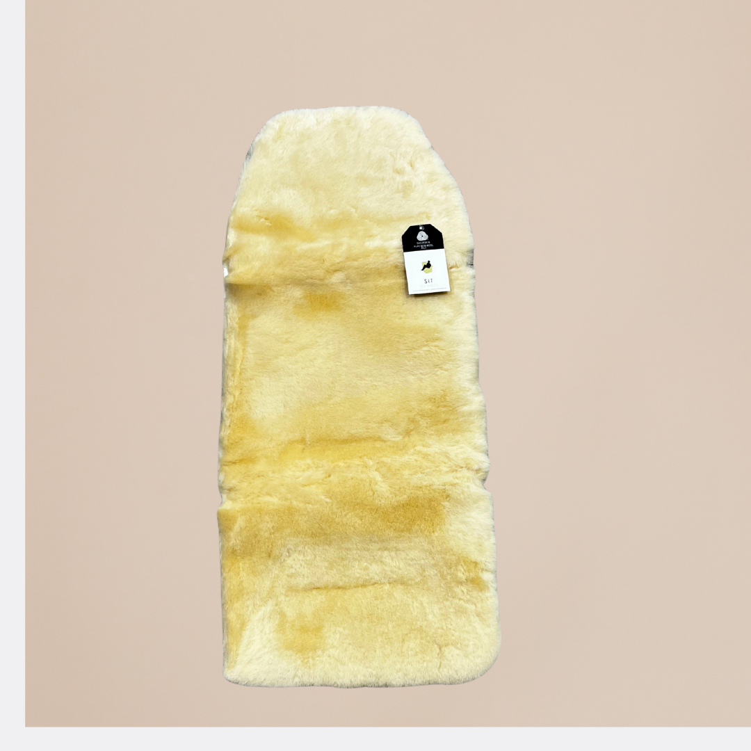 Beige fur product with a tag on a beige background