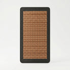 Rectangular mat with brown woven pattern and black border on a white background