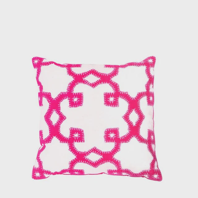 Decorative pillow with pink geometric pattern on a white background