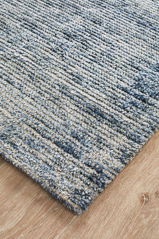 Focused image showing the edge of the Allure Rug, highlighting the precision of its construction and the harmonious blend of materials.