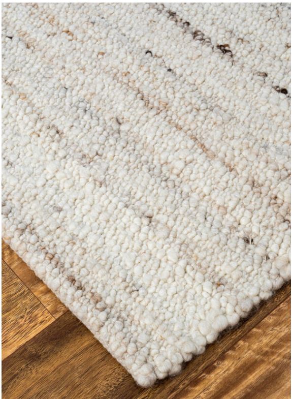 Detailed image showing the neat edging and durable backing of Noosa Mats & Rugs' Belgium Handwoven Wool Rug in Mushroom, exemplifying its superior quality and finish.