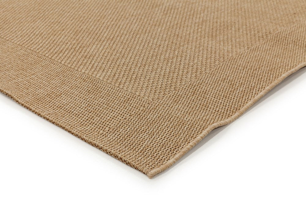 Zoomed-in view of the corner of the Noosa Rug's Outdoor Rug in Sand, showcasing the precision of its edges and the overall durability of the rug.