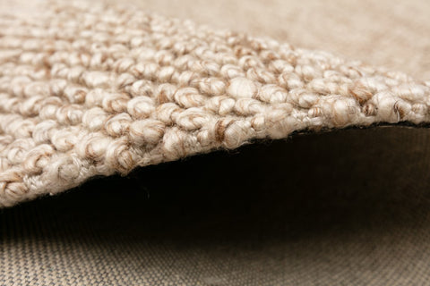 Artisanal Avenue Rug in a natural beige shade, portraying the blend of traditional hand weaving techniques with contemporary design.