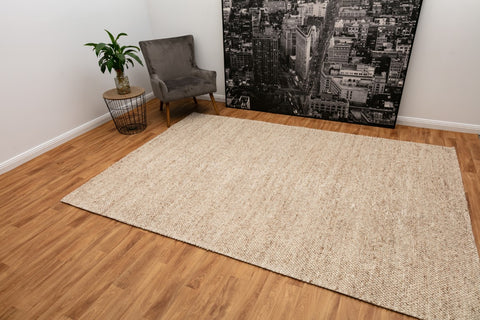 Sophisticated Beige Avenue Rug laid out in a living room, complementing the decor with its versatile color and sustainable elegance.