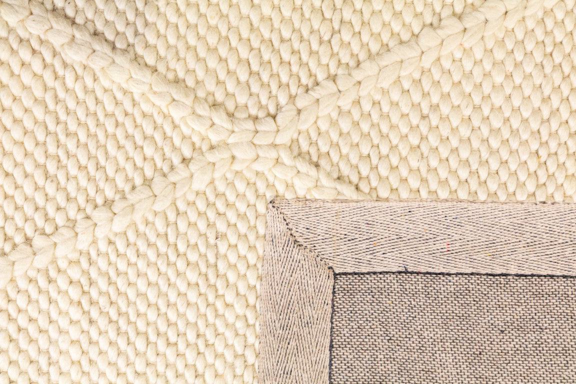 Detailed view of the Colombo Cream Rug's fibers and underside, displaying the high-quality craftsmanship, dense pile, and durable weave of the hand-made New Zealand wool rug.